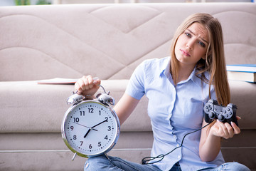 Female student being distracted from exam preparation