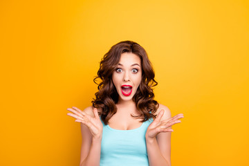 Portrait of scared mad girl yelling with wide open mouth isolated on yellow background. Sale...