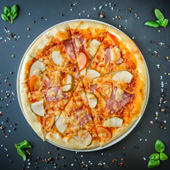 Hawaiian Italian pizza on a dark background