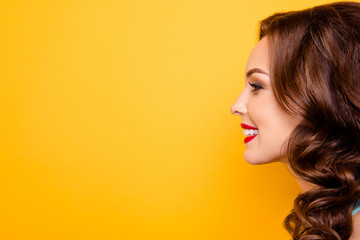 Close up profile portrait with copy space empty place for advertisement of cheerful positive elegant girl with red lipstick makeup isolated on yellow background © deagreez
