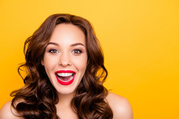 Portrait with copy space empty place of funny laughing girl with beaming white straight teeth having playful crazy foolish mood isolated on yellow background