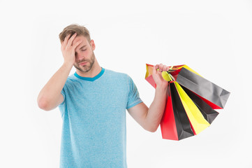 Tired man with shopping bags isolated on white. Macho with colorful paper bags. Fashion shopper in...