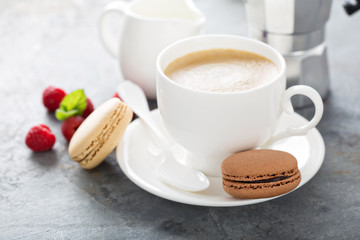 A cup of espresso coffee with macarons