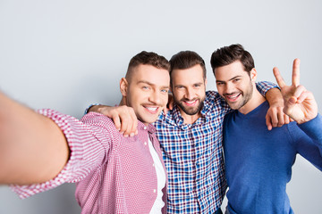 Self portrait of cheerful, positive, cool, stunning, virile, modern guys shooting selfie on smart...