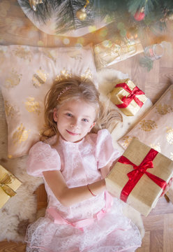 Smiling female kid with lots of presents