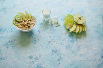 Fototapeta na wymiar Breakfast with muesli. Granola with kiwi, apples and sweets on a blue background.