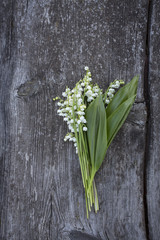 lillies of the valley on wooden surface