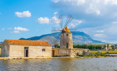 View of a windmill in the Saline di Trapani e Paceco natural reserve near Trapani, Sicily, Italy