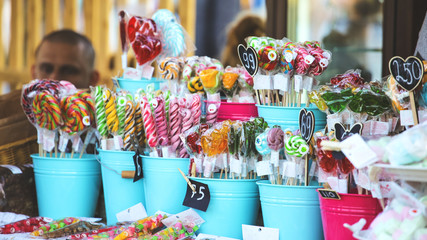 caramels on sticks in a shop on a show-window