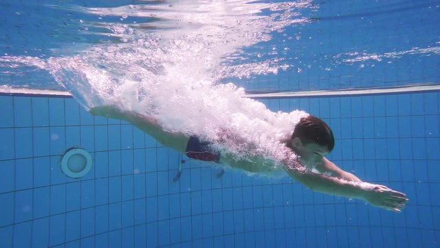 Boy dive in swimming pool