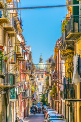 View of a narrow street leading to chiesa del carmine maggiore in Palermo, Sicily, Italy
