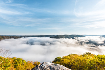 Mountains and fog, mist clouds in morning floating above forest trees, covering, blanketing valley in Grandview Overlook, West Virginia