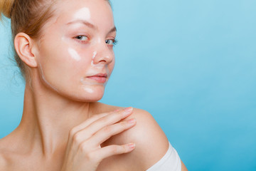 Woman in facial peel off mask.