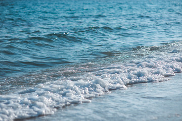 Gentle waves crashing on a sandy beach