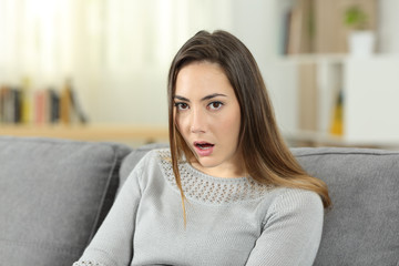 Perplexed woman looking at camera at home