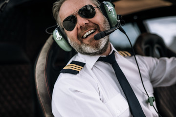 Smiling helicopter pilot with headset © Jacob Lund