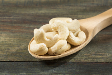 Cashew nut on wooden background - Anacardium occidentale