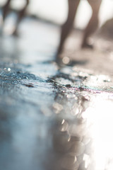 Blurred view of seashore with child legs in the background