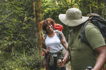 Couple trekking in the forest together