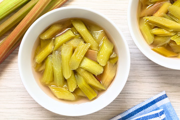 Fresh homemade rhubarb compote in two bowls, photographed overhead with natural light (Selective Focus, Focus on the top of the compote)