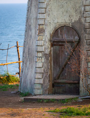 Fototapeta na wymiar Old wooden door in brick wall in monastery