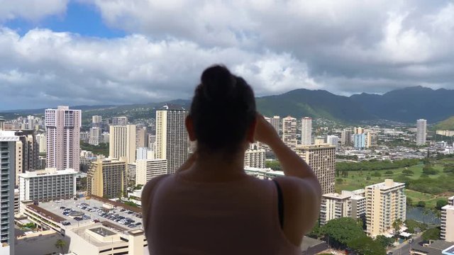Professional video of young woman taking pictures of the beautiful view in 4K Slow motion 60fps