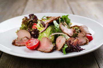 Appetizing salad with veal and cherry tomatoes, restaurant serving. Mediterranean food, banquet, restaurant menu, dining concept