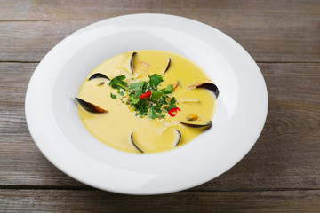 Appetizing gourmet Mediterranean seafood cream soup with mussels. Foodie, banquet, restaurant menu, dining concept