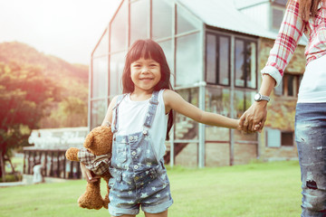 A Mother and daughter in front of the house