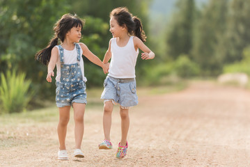 two girl relaxxing on the road in country side