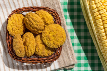 Delicious yellow cookie of corn on basket and corn cob. Sweet food of Festa Junina, a typical brazilian party.