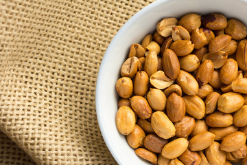 Peanuts. Food of Festa Junina, a typical brazilian party. Snacks on bowl and jute, burlap fabric.