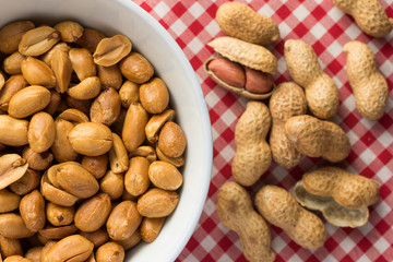 Peanuts. Food of Festa Junina, a typical brazilian party. Snack on plate, red plaid table.