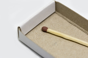 single matchstick with a box