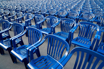 Plastic hire chairs in a row blue color