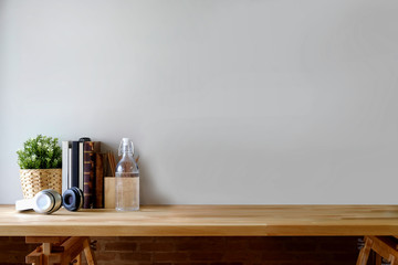 Workplace and copy space with home office supplies on wooden table.