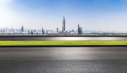 Fototapeta na wymiar Panoramic skyline and buildings with empty road