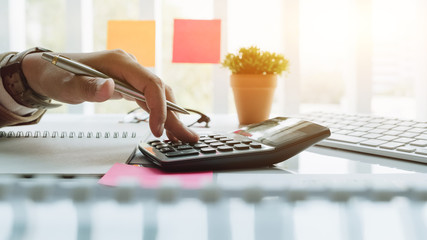Close up view of bookkeeper or financial inspector hands making report, calculating or checking...