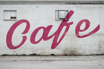 "Cafe" sign on the side of a building