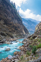 Fototapeta na wymiar Mountain river in a deep gorge in the Himalayas.