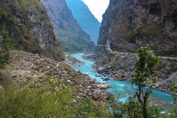 Fototapeta na wymiar Mountain river in a deep gorge in the Himalayas.