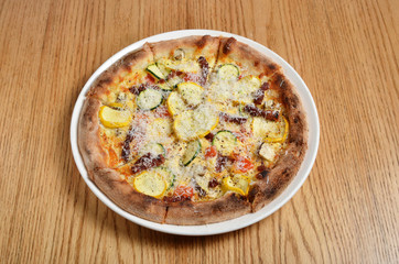 Vegetable omelette pizza on wooden table