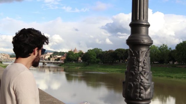 Tourist boy near Arno in Florence