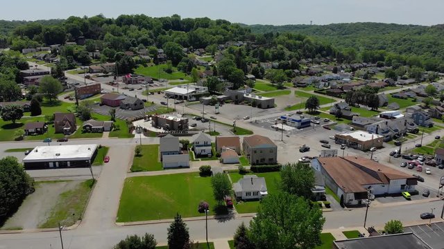 A slowly moving forward aerial establishing shot of a small town's business district. Pennsylvania suburbs.  	