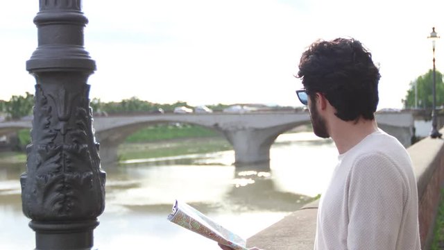 Tourist boy near Arno in Florence
