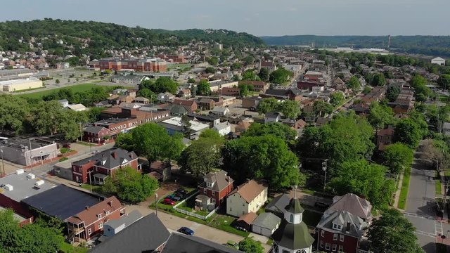 A daytime slow forward aerial view of a small Pennsylvania town's residential neighborhood. Pittsburgh suburbs.  	