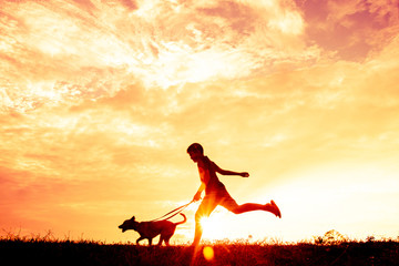 Silhouette child playing with dogs, Concept play with dog.