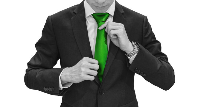 Businessman In Green Suit Tying Green Necktie. Environmental, Agriculture And Green Business, Isolated On White Background