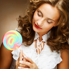 curly  girl with a lollipop in her hand 