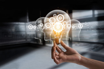 Hand holding light bulb and cog inside. Idea and imagination. Creative and inspiration. Innovation gears icon with network connection on human heads. Innovative technology in science concept
